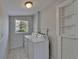 Laundry room with washer, dryer, window, light and shelves at 1312 E Louise Ave, Tampa, FL 33603