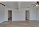 Spacious living room featuring doorways, wood-look floors, and ceiling fans at 1312 E Louise Ave, Tampa, FL 33603