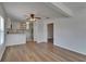 Open-concept living room and kitchen area with hardwood floors and updated white cabinets at 1312 E Louise Ave, Tampa, FL 33603