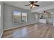 Bright, open-concept living room featuring wood-look floors and contemporary ceiling fans at 1312 E Louise Ave, Tampa, FL 33603