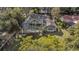 An aerial view of a house with a screened pool surrounded by lush trees and grass at 13811 Shady Shores Dr, Tampa, FL 33613