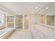 Spacious bathroom with a large soaking tub, glass-enclosed shower, dual sinks, and ample cabinet space at 13811 Shady Shores Dr, Tampa, FL 33613