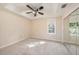 Comfortable bedroom featuring plush carpeting, a tray ceiling, and a mirrored closet at 13811 Shady Shores Dr, Tampa, FL 33613
