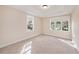 Cozy bedroom featuring neutral carpeting and large windows that provide natural light at 13811 Shady Shores Dr, Tampa, FL 33613