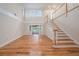 Elegant staircase with a white railing and hardwood floors at 13811 Shady Shores Dr, Tampa, FL 33613