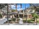 Traditional two-story home with a brick and siding facade and manicured landscaping at 13811 Shady Shores Dr, Tampa, FL 33613