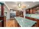 Kitchen with custom wood cabinets, stainless fridge, granite counters, and tile backsplash at 13811 Shady Shores Dr, Tampa, FL 33613