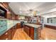 Well-equipped kitchen features wood cabinetry and a center island with granite countertops at 13811 Shady Shores Dr, Tampa, FL 33613
