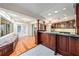 Open kitchen and bar area, featuring granite counters and custom wood cabinetry at 13811 Shady Shores Dr, Tampa, FL 33613