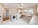 Functional laundry room with washer, dryer, sink, storage cabinets, and countertop space at 13811 Shady Shores Dr, Tampa, FL 33613