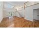 Spacious living room with hardwood floors and sliding doors that lead to a pool at 13811 Shady Shores Dr, Tampa, FL 33613