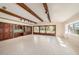 Spacious living area with built-in seating, wood beams, and tile floors at 13811 Shady Shores Dr, Tampa, FL 33613