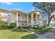 Exterior of condo building with walkway and landscaping at 1408 Millstream Ln # 206, Dunedin, FL 34698