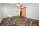 Spacious bedroom with hardwood floors and barn door at 17504 Marsh Rd, Lutz, FL 33558