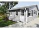 Gray house exterior with white door and landscaping at 2172 18Th Sw Ave, Largo, FL 33774