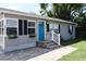 Gray house with a blue door, stone walkway, and landscaping at 2172 18Th Sw Ave, Largo, FL 33774