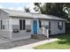 Gray house with a blue door, stone walkway, and landscaping at 2172 18Th Sw Ave, Largo, FL 33774