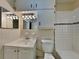 Bathroom with white tile, vanity, and toilet at 315 Lime Tree Rd, Tampa, FL 33619