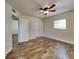 Bright bedroom with wood-look floors, ceiling fan, and double closets at 315 Lime Tree Rd, Tampa, FL 33619