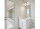 Bright bathroom features a white vanity and a door to the backyard at 35298 Big Hawk Dr, Zephyrhills, FL 33541