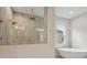 Bathroom featuring a walk-in shower and soaking tub at 35298 Big Hawk Dr, Zephyrhills, FL 33541