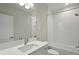 Bright bathroom with a wide mirror above a quartz countertop and shower-tub combination at 35298 Big Hawk Dr, Zephyrhills, FL 33541
