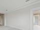 Bedroom featuring gray carpeting, trim, and a white door at 35298 Big Hawk Dr, Zephyrhills, FL 33541