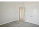 Bedroom with neutral colored walls and carpet flooring featuring a closet and open doorway at 35298 Big Hawk Dr, Zephyrhills, FL 33541