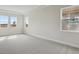Spacious bedroom featuring large windows and plush carpeting at 35298 Big Hawk Dr, Zephyrhills, FL 33541