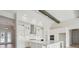 Bright, open kitchen boasts white cabinetry, stainless steel appliances, and an island with a sink at 35298 Big Hawk Dr, Zephyrhills, FL 33541