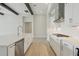 Modern kitchen with an island, stainless steel appliances, gas cooktop and white cabinetry at 35298 Big Hawk Dr, Zephyrhills, FL 33541