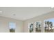 Spacious living room with large windows, letting in ample natural light at 35298 Big Hawk Dr, Zephyrhills, FL 33541