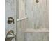 Beautiful shower with large light-colored tiles and a built-in bench and chrome fixtures at 35298 Big Hawk Dr, Zephyrhills, FL 33541