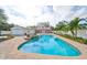 Large kidney shaped pool with attached spa and brick decking at 6657 Bougainvilla S Ave, St Petersburg, FL 33707