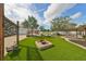 Artificial turf lawn, fire pit, and view of pool and home at 6657 Bougainvilla S Ave, St Petersburg, FL 33707