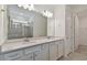 Elegant bathroom featuring a double sink vanity and a large glass-enclosed shower at 9434 Shorebird Ct, Parrish, FL 34219