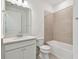 Clean bathroom features a vanity with white cabinets, tub/shower combo, and neutral finishes at 9434 Shorebird Ct, Parrish, FL 34219