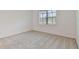Cozy bedroom with plush carpeting and a bright window offering natural light at 9434 Shorebird Ct, Parrish, FL 34219