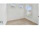 Bright bedroom with hard wood floors, white walls and natural light streaming through windows at 9434 Shorebird Ct, Parrish, FL 34219