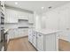 Bright kitchen features white cabinets, stainless appliances, subway tile backsplash, and a large island at 9434 Shorebird Ct, Parrish, FL 34219