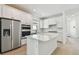 Modern kitchen featuring stainless steel appliances, a large island, and sleek white cabinets at 9434 Shorebird Ct, Parrish, FL 34219