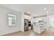Bright kitchen with stainless appliances, white cabinets, and an island open to the living area at 9434 Shorebird Ct, Parrish, FL 34219