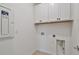 Laundry room features built-in cabinets for storage and convenient utility connections at 9434 Shorebird Ct, Parrish, FL 34219