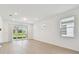 Bright living room with sliding glass doors and light wood floors at 9434 Shorebird Ct, Parrish, FL 34219