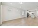 Bright, open-concept living space with hardwood floors connects to modern kitchen at 9434 Shorebird Ct, Parrish, FL 34219