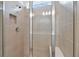 Modern walk-in shower featuring tiled walls, a rainfall shower head, and a built-in niche at 9434 Shorebird Ct, Parrish, FL 34219