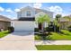 Two-story house with light blue exterior and a two-car garage at 12403 Ballentrae Forest Dr, Riverview, FL 33579