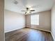 Spacious bedroom featuring wood-look flooring and a ceiling fan at 12403 Ballentrae Forest Dr, Riverview, FL 33579