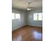 Bright bedroom featuring wood floors and ceiling fan at 12501 Ulmerton Rd # 119, Largo, FL 33774