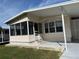 Mobile home with covered awning and screened porch at 12501 Ulmerton Rd # 119, Largo, FL 33774